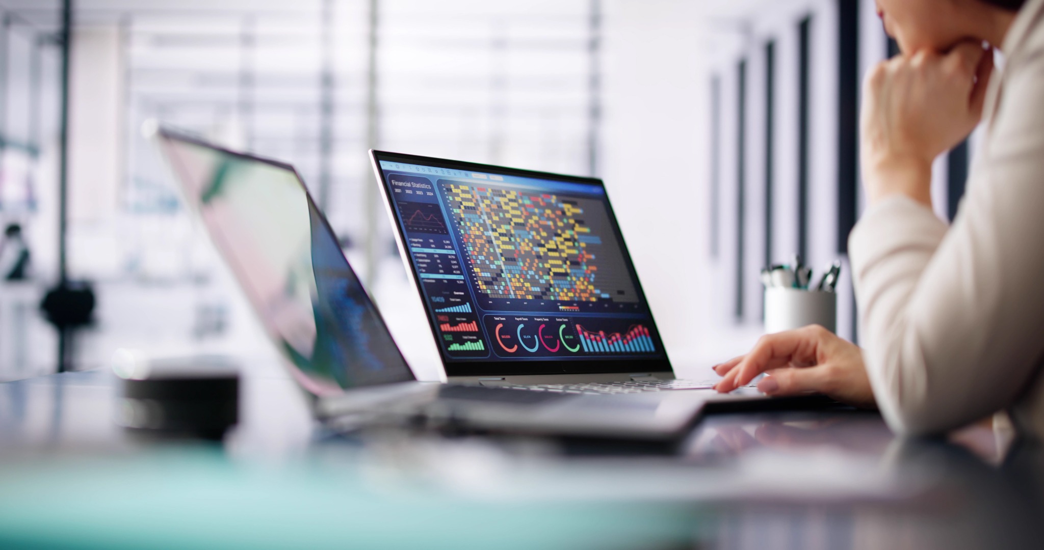 A person reviewing data dashboards on a laptop